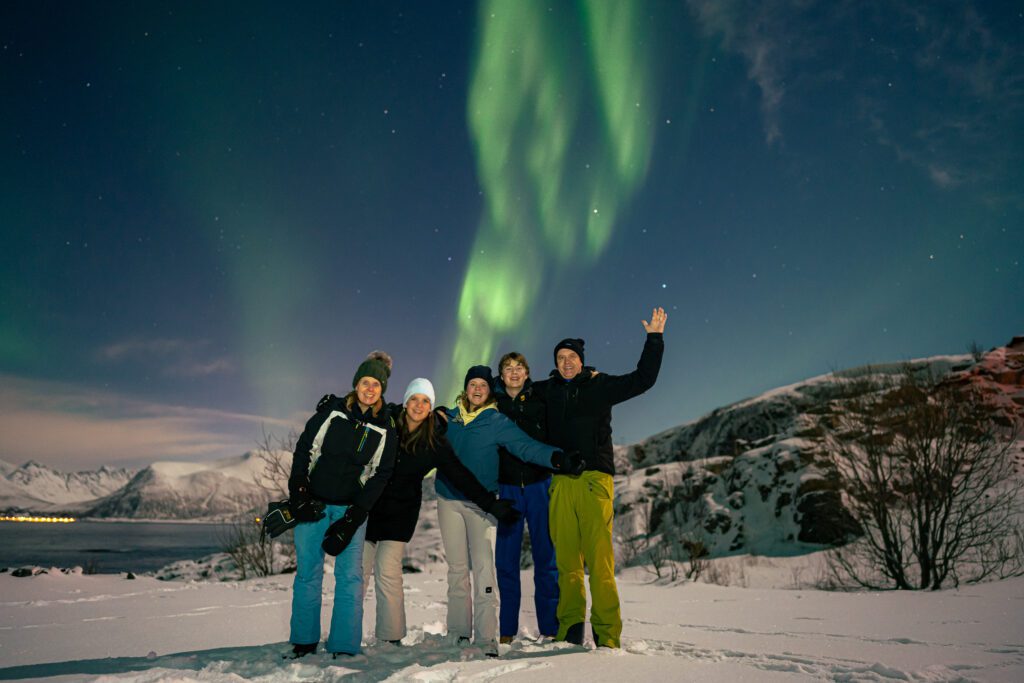 Tourists having fun during a northern lights chase with Best Arctic