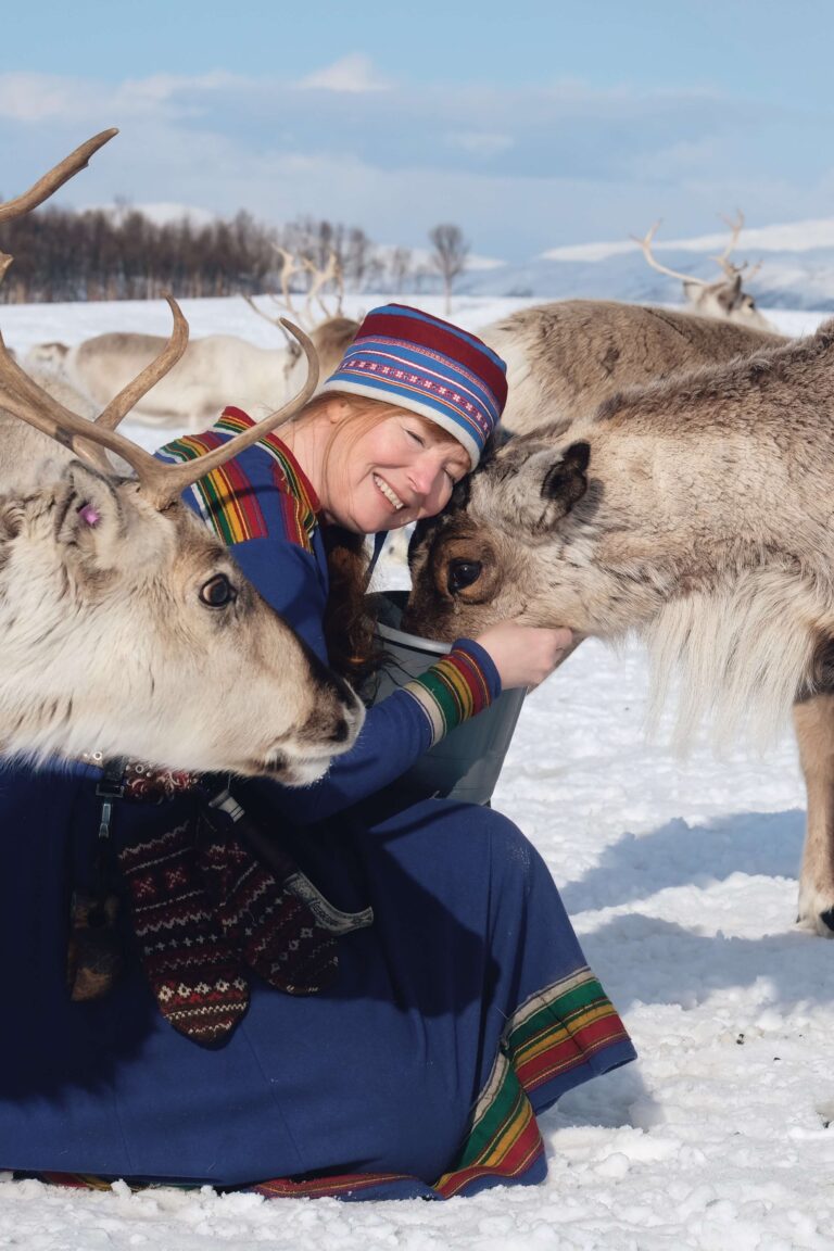 Sami woman with reindeer