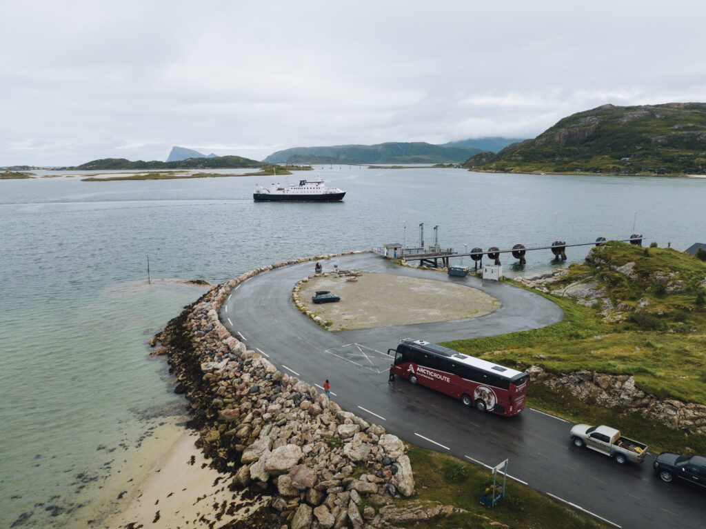 Aerial view of Brensholmen in Northern Norway with an Arctic Route bus and a ferry on the water
