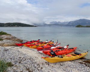 Kayaks on white sand beach in Northern Norway