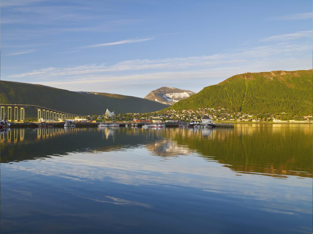 tromsø in the summer with green mountains and midnight sun