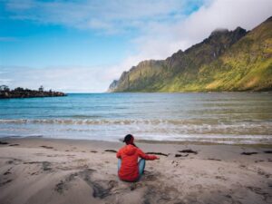 Girl sitting at a beach in Senja, Norway