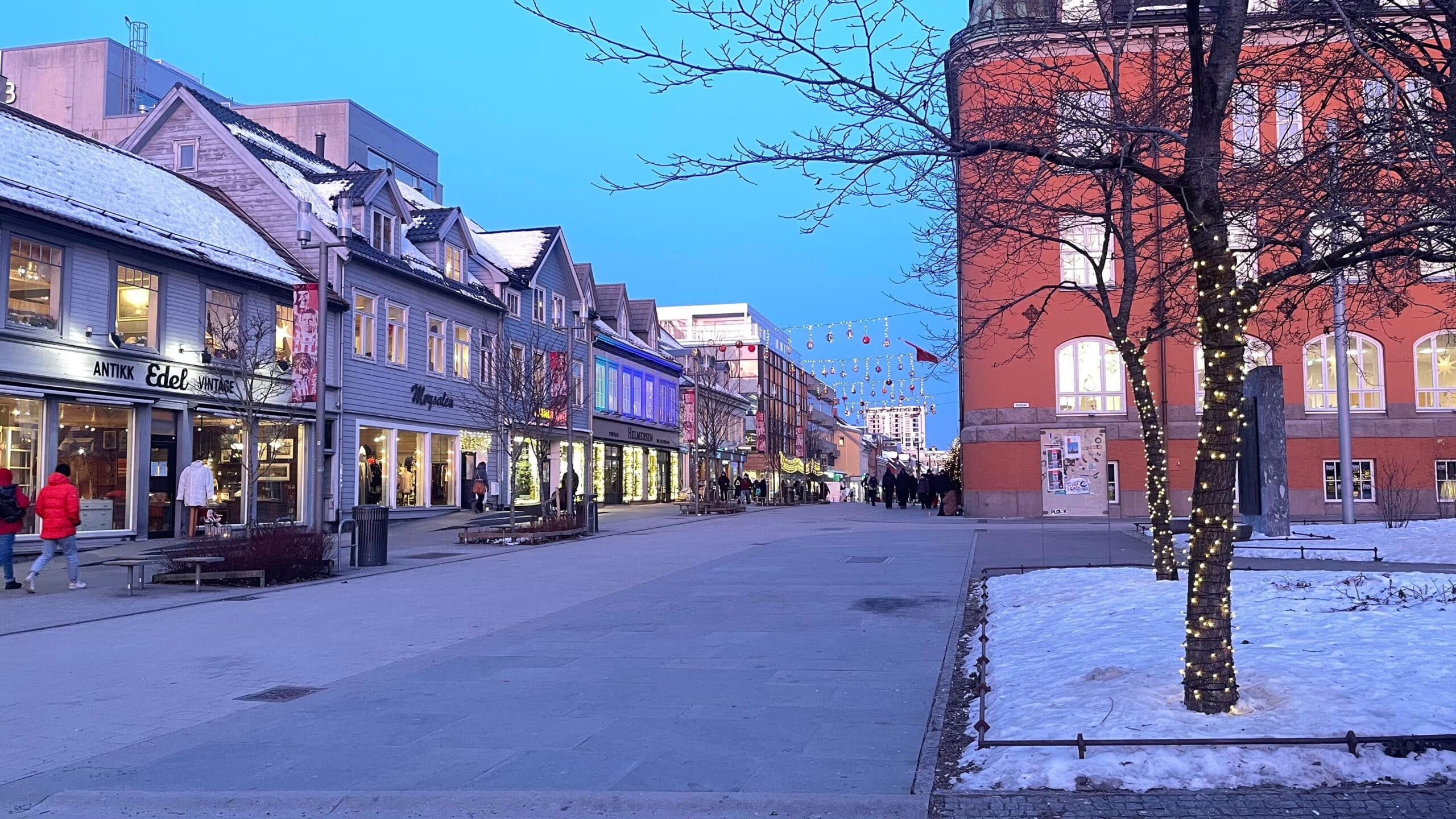 Storgata street in Tromsø, Norway during the evening with snow and Christmas decorations