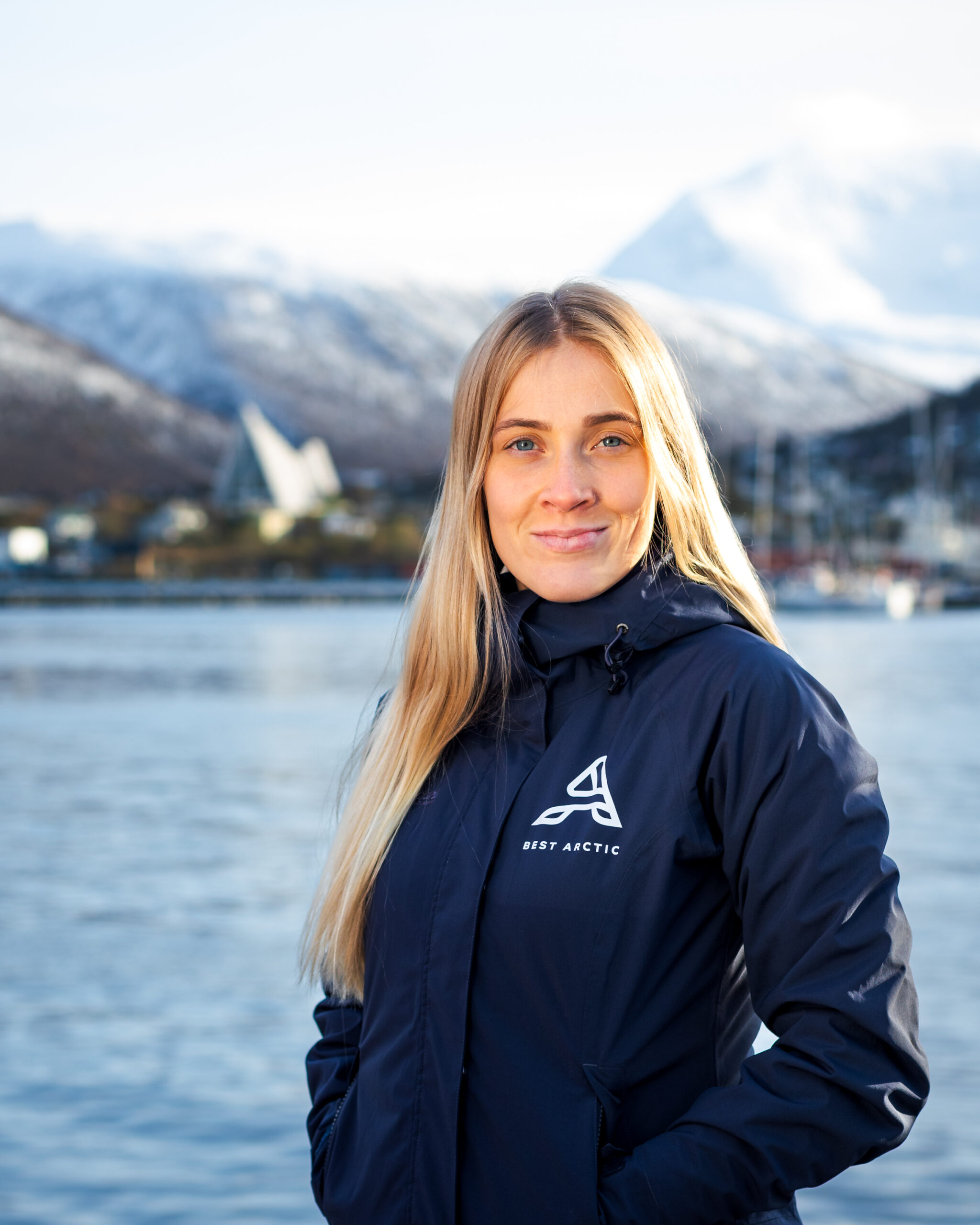 Portrait of a young woman, Lotta, with Tromsø city blurred in the background