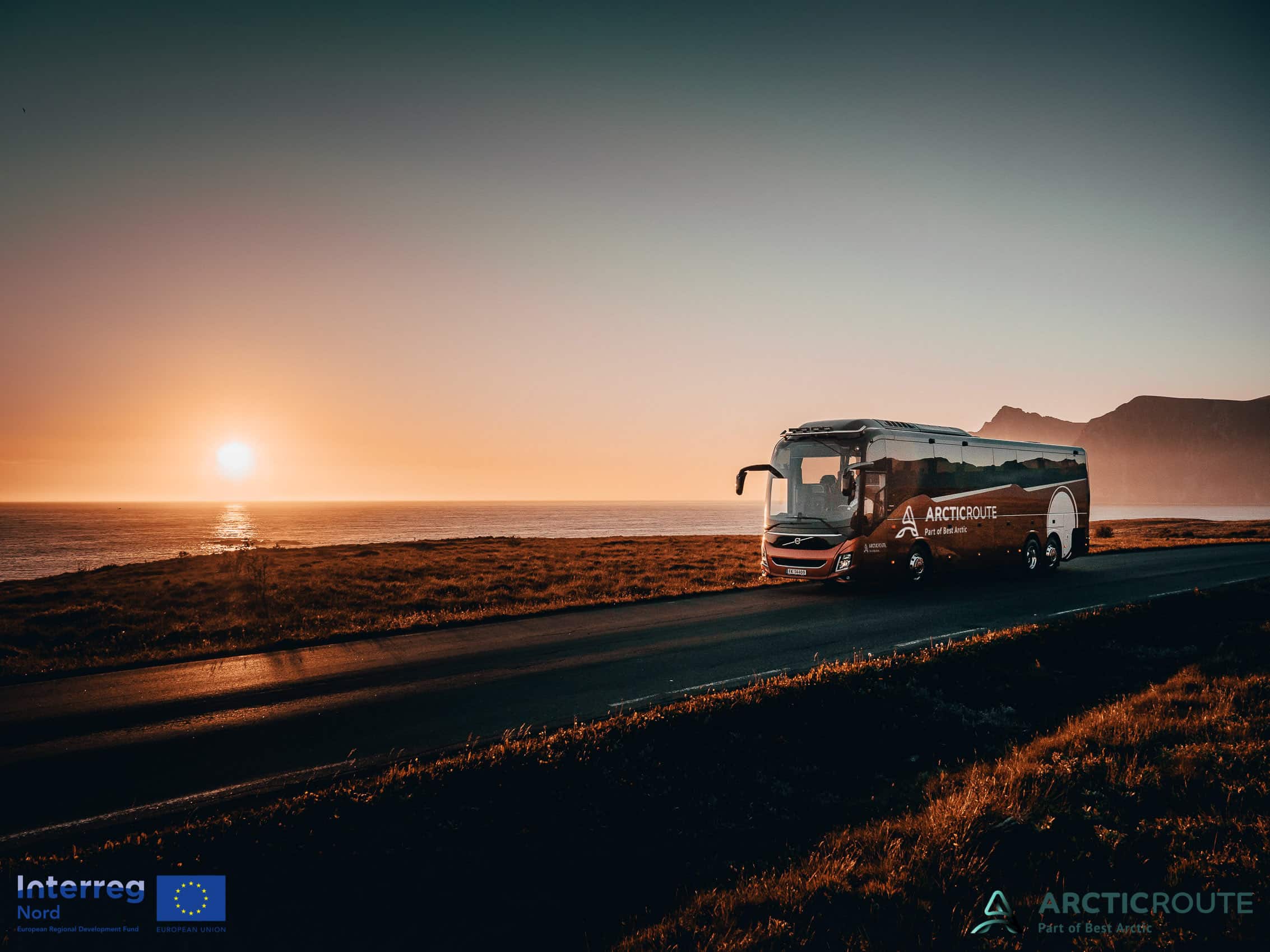 Red Arctic Route bus driving along the coast in northern Norway