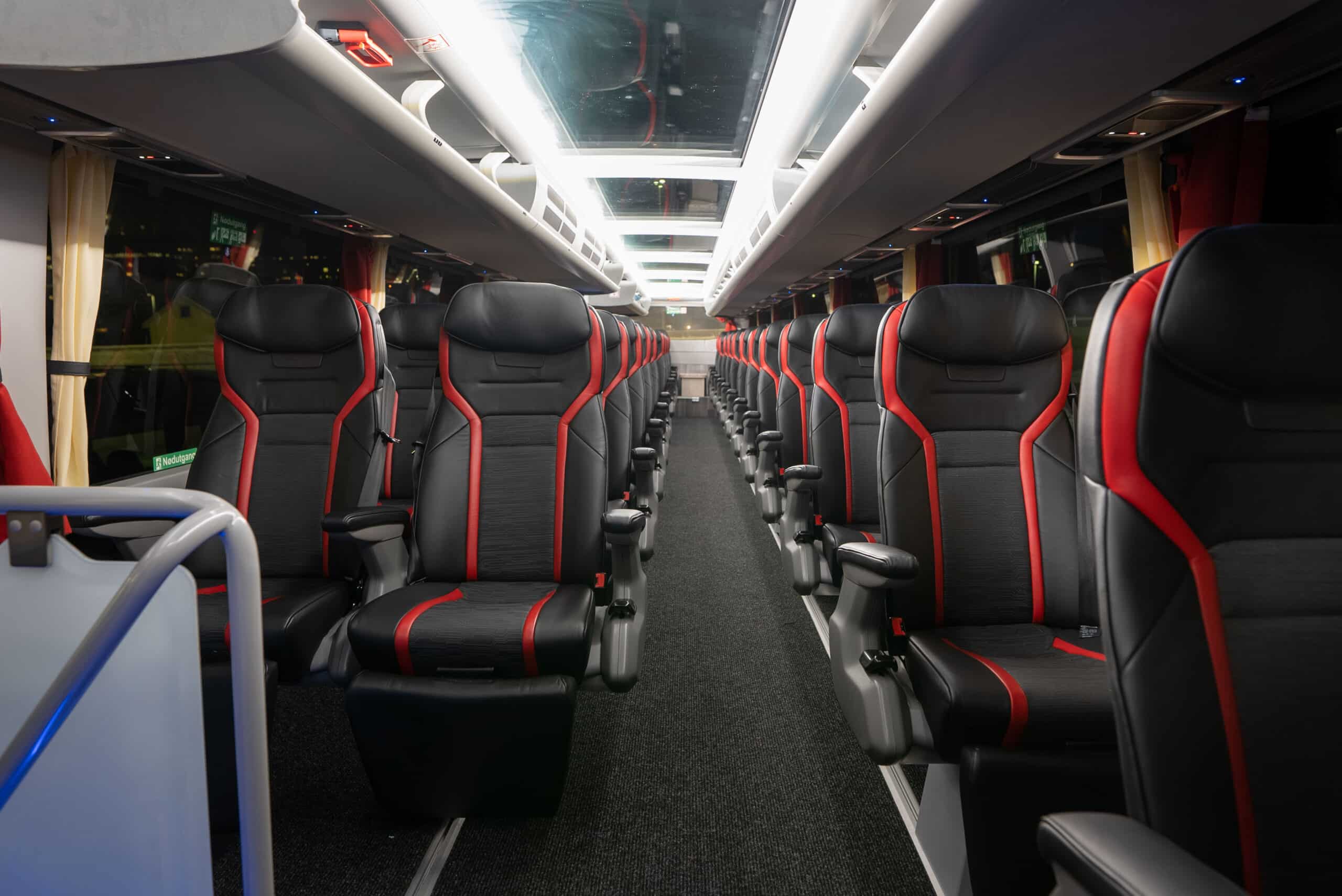 Interior of the Aurora Express bus top deck with glass ceiling and semi-reclining seats